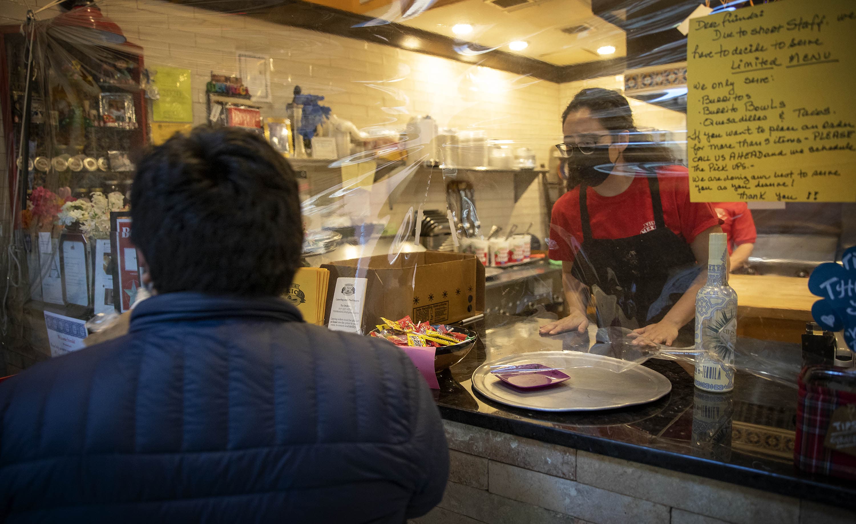 Bessie King talks with a customer at the Villa Mexico Cafe in Boston's Financial District. The restaurant just reopened after five months. (Robin Lubbock/WBUR)