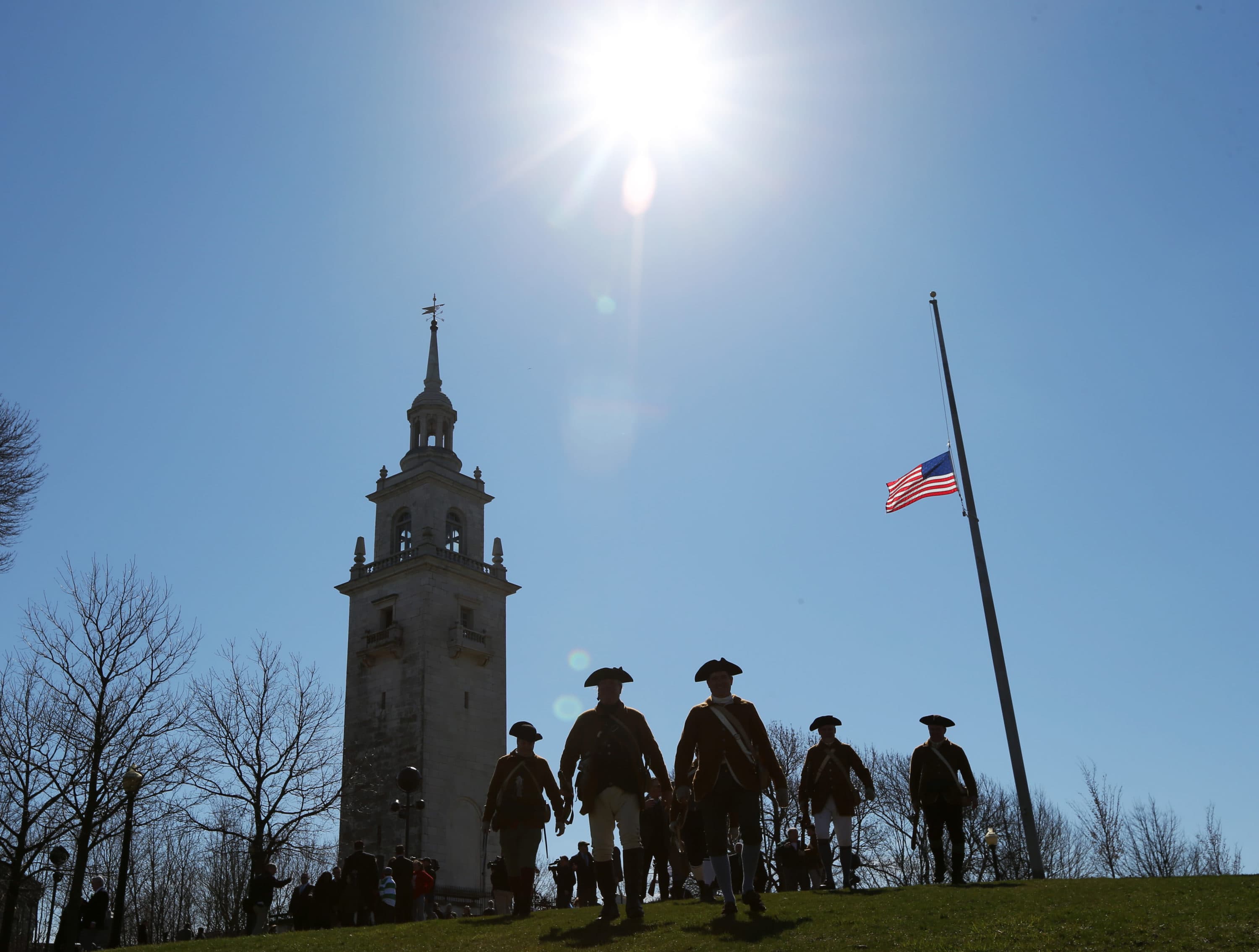 Members of the Lexington Minute Men walk down Telegraph Hill after commemorating the 240th anniversary of the fortification of Dorchester Heights and the British military evacuation of Boston on March 17, 1776. (David L. Ryan/The Boston Globe via Getty Images)