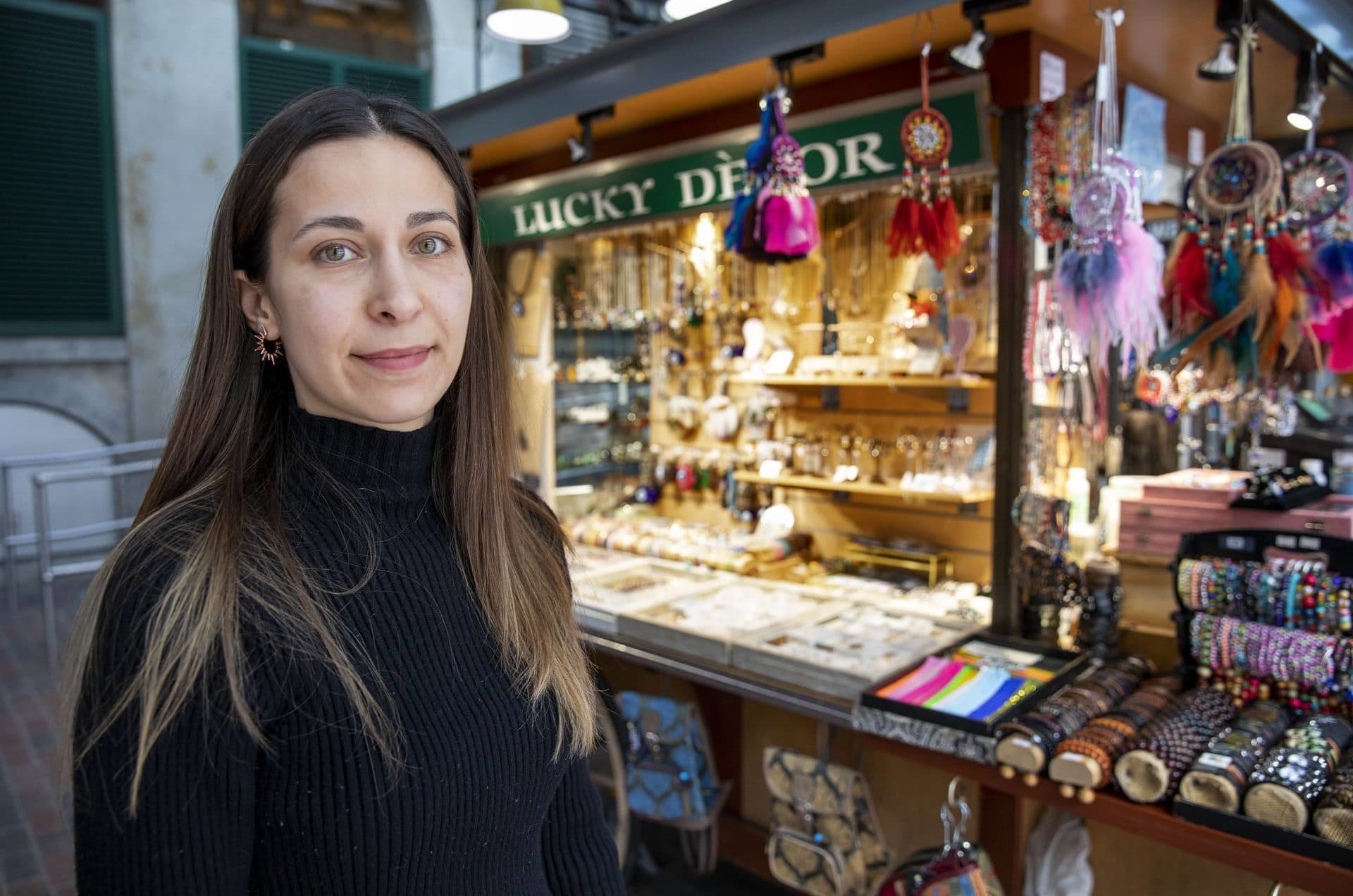 Elif Murat, owner of Lucky Decor, by her stand in Faneuil Hall Marketplace. (Robin Lubbock/WBUR)