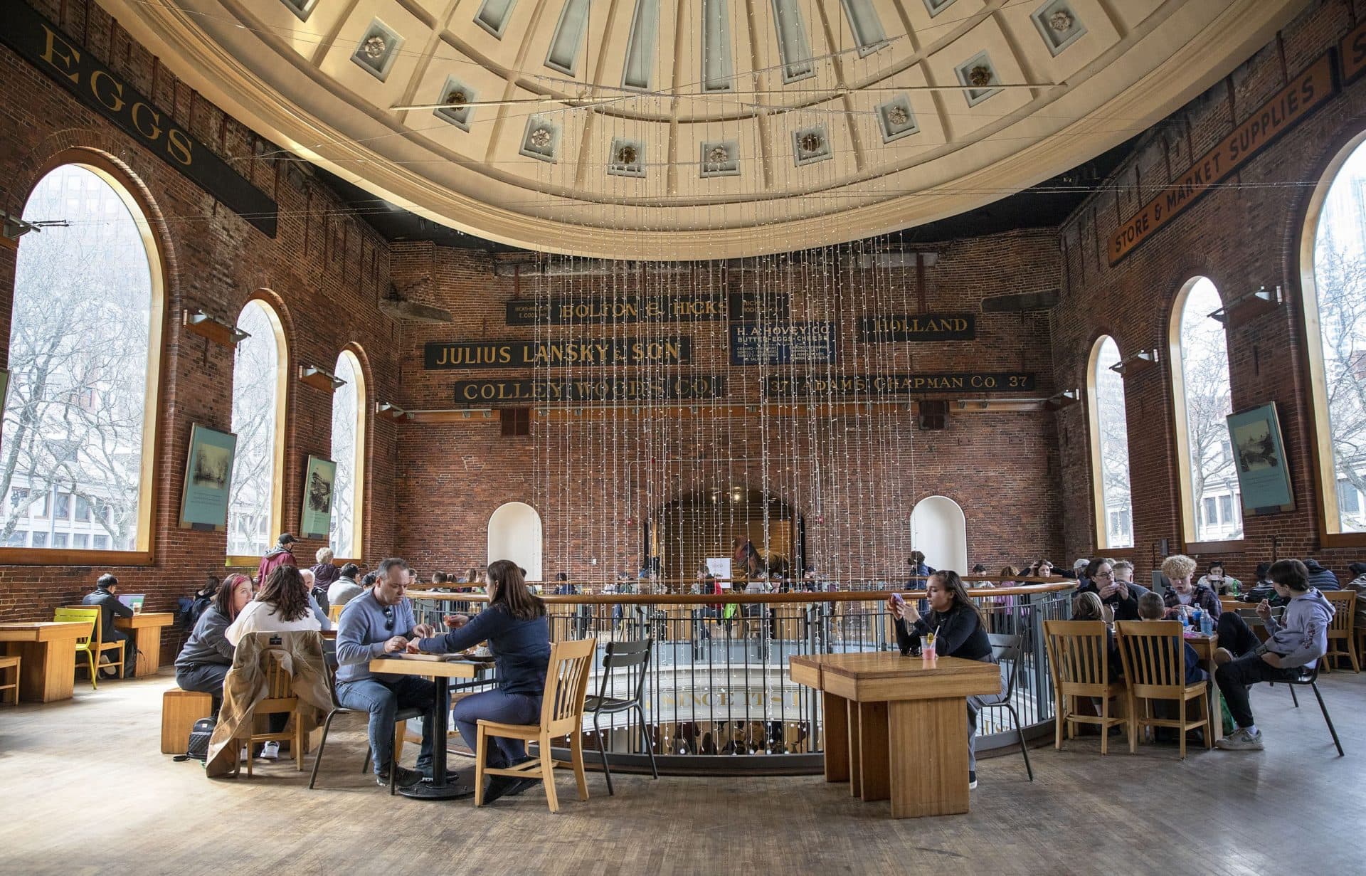 At lunchtime tables are filled upstairs in the rotunda at Quincy Market. (Robin Lubbock/WBUR)