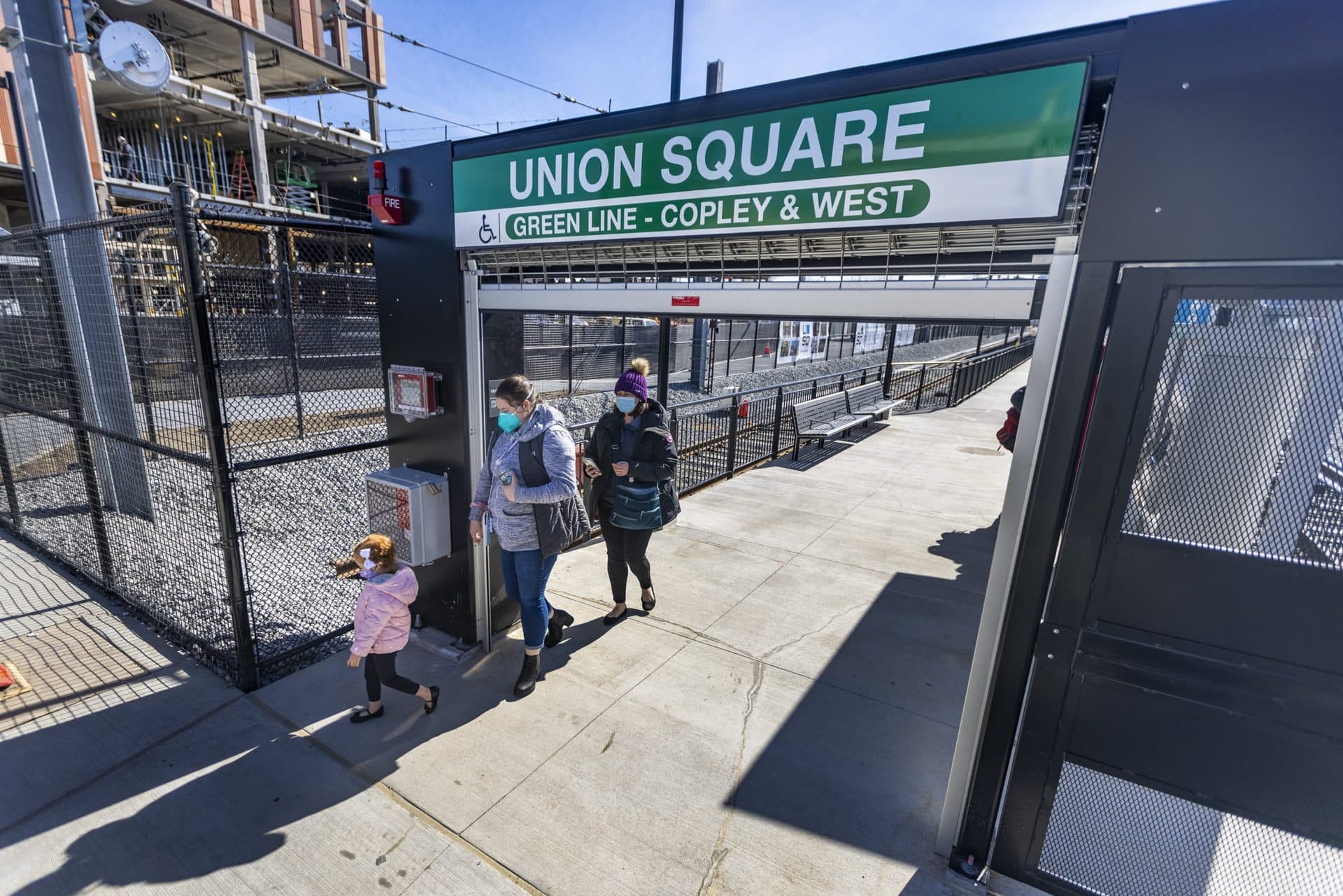 Riders walk through the entranceway of the new MBTA Union Square Station. (Jesse Costa/WBUR)
