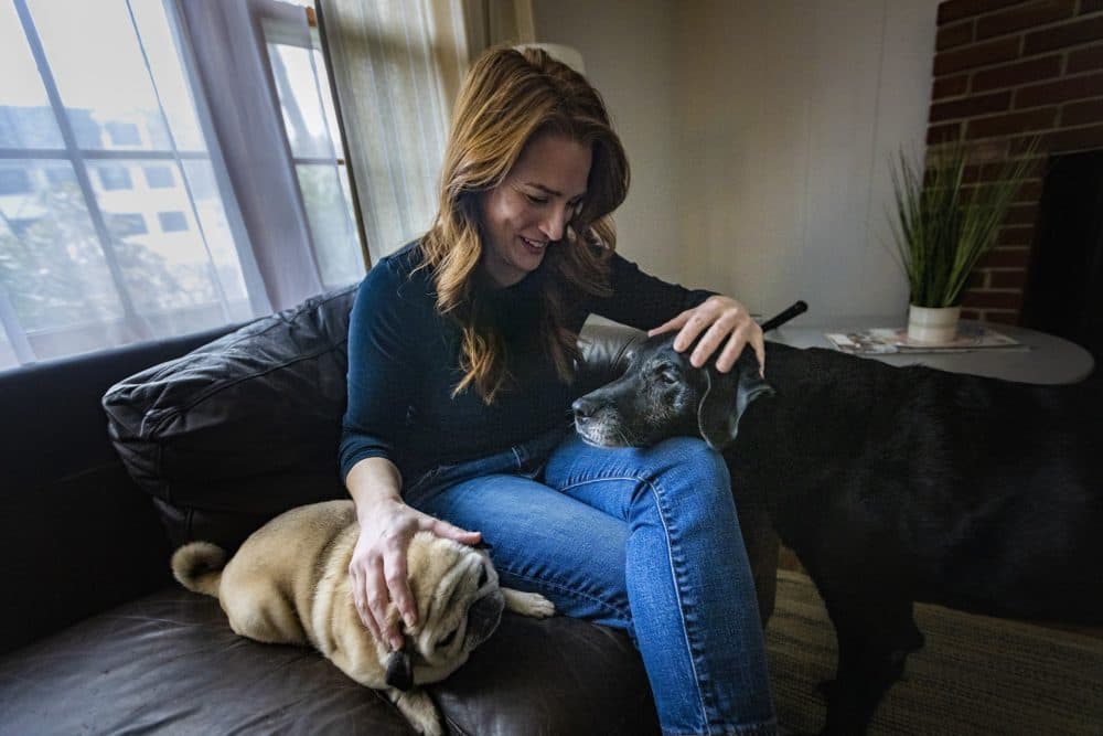 Sarah Ortiz with her dogs Bailey and Addison at her home. (Jesse Costa/WBUR)
