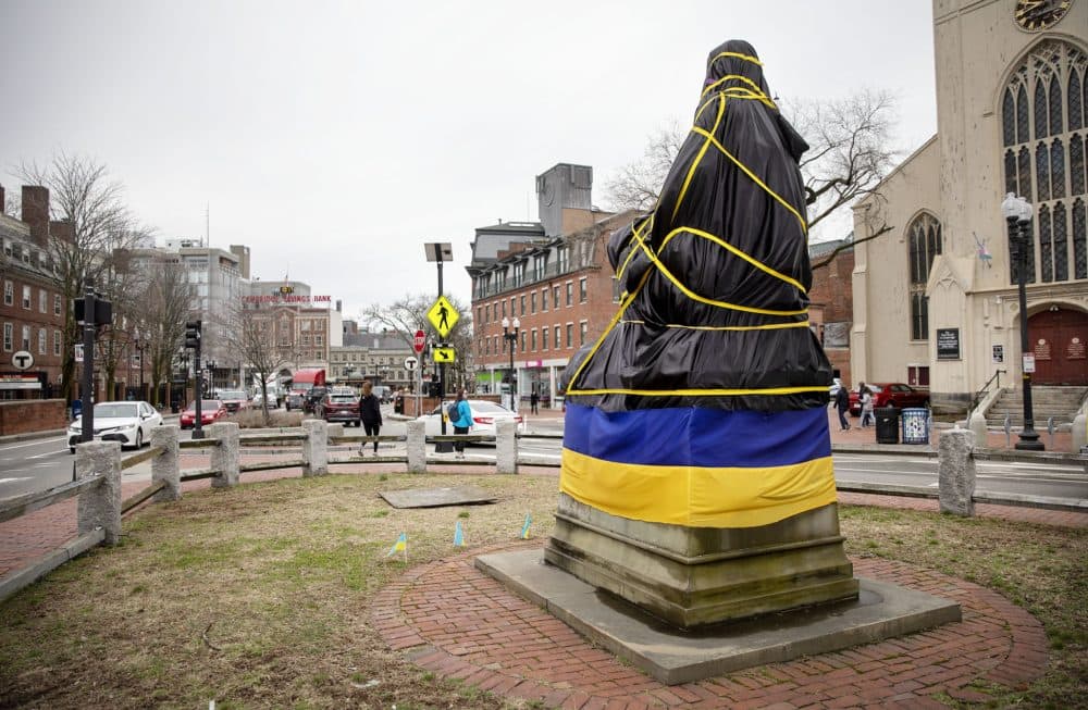 The statue of Charles Sumner in Harvard Square, wrapped by artists Ross Miller and Yolanda He Yang. (Robin Lubbock/WBUR)
