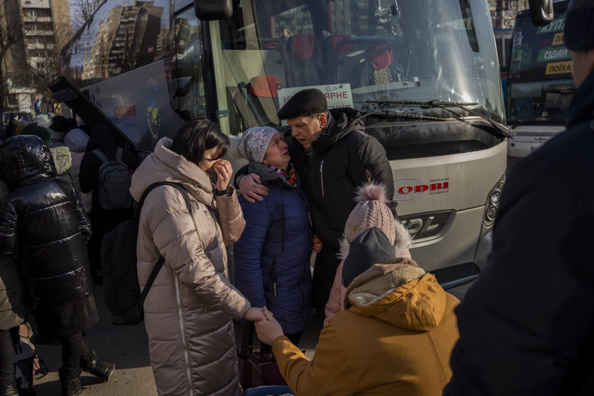 Ukrainian families say goodbye as they prepare to board a bus to Poland at Lviv bus main station, western Ukraine on March 1. (Bernat Armangue/AP)