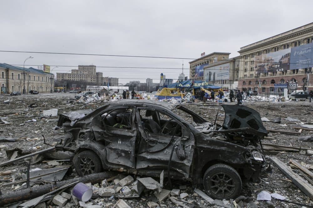 A damaged car sits at the central square following shelling of the City Hall building in Kharkiv, Ukraine, on, March 1, 2022. (Pavel Dorogoy/AP)