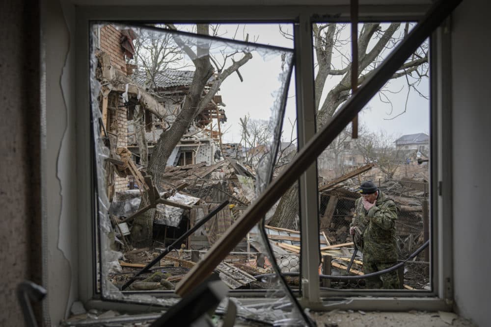 Andrey Goncharuk, 68, a member of territorial defense wipes his face in the backyard of a house that was damaged by a Russian airstrike, according to locals, in Gorenka, outside the capital Kyiv, Ukraine, on March 2, 2022. (Vadim Ghirda/AP)