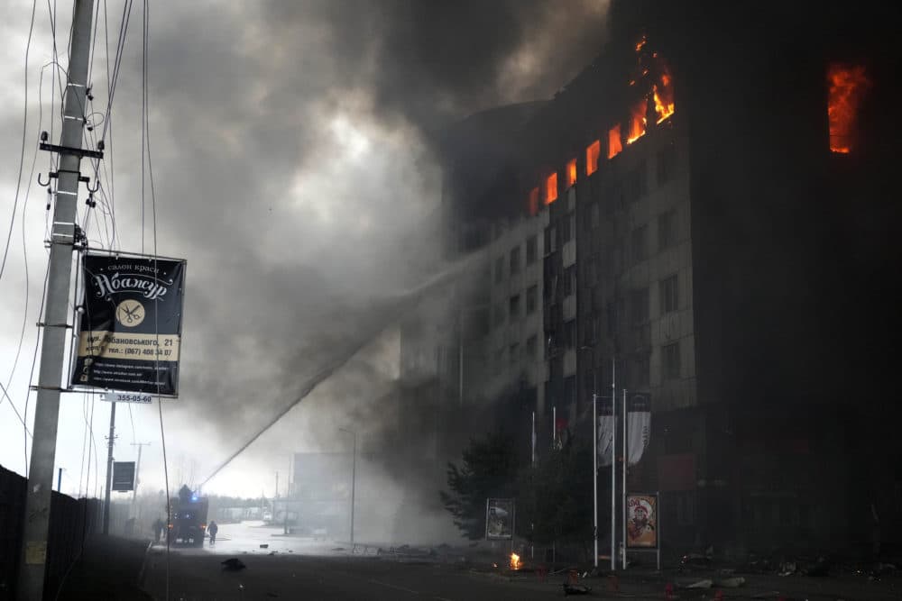 Firefighters hose down a burning building after bombing in Kyiv, Ukraine, Thursday, March 3, 2022. (Efrem Lukatsky/AP)