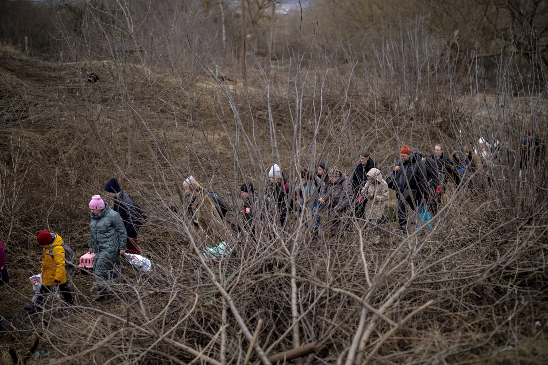 Ukrainian citizens flee crossing the Irpin river in the outskirts of Kyiv, Ukraine on Saturday, March 5. (Emilio Morenatti/AP)