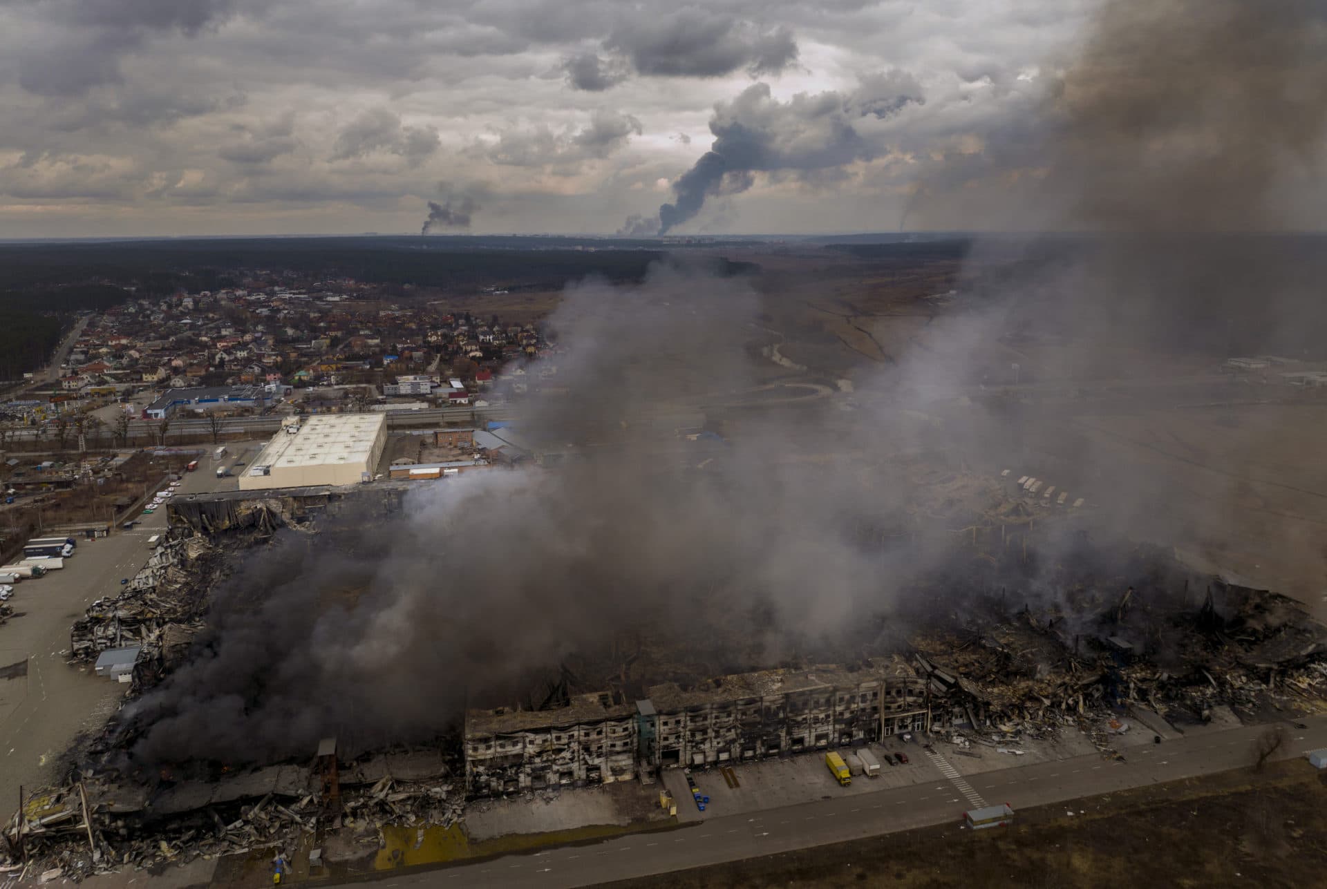 A factory and a store are burning after been bombarded in Irpin, in the outskirts of Kyiv, Ukraine on Sunday, March 6. (Emilio Morenatti/AP)