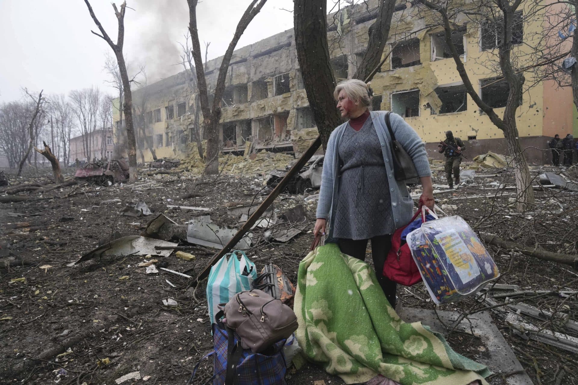 A woman walks outside a maternity hospital that was damaged by shelling in Mariupol, Ukraine, March 9, 2022. (Evgeniy Maloletka/AP)