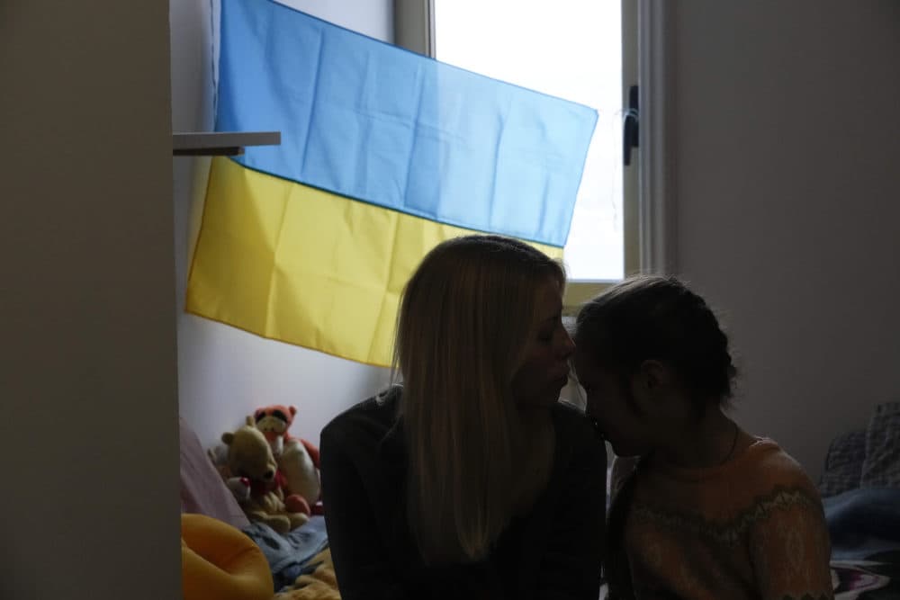 A woman kisses her daughter as she is hosted with other 30 Ukrainian refugees at a Ukrainian Monastery in Castel Gandolfo, in the outskirts of Rome, on March 11, 2022. (Gregorio Borgia/AP)