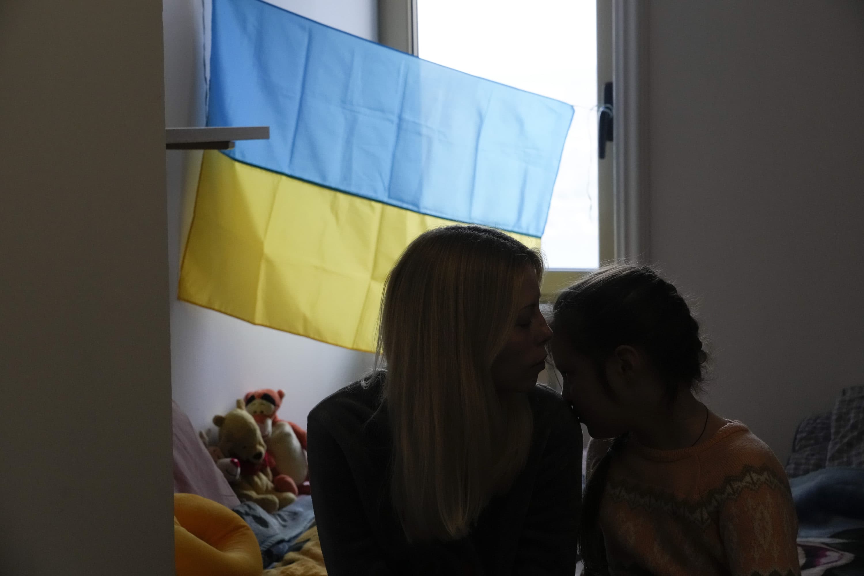 A woman kisses her daughter as she is hosted with other 30 Ukrainian refugees at a Ukrainian Monastery in Castel Gandolfo, in the outskirts of Rome, on March 11, 2022. (Gregorio Borgia/AP)