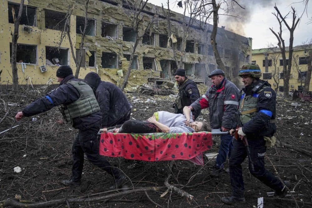 Ukrainian emergency employees and volunteers carry an injured pregnant woman from a maternity hospital damaged by shelling in Mariupol, Ukraine, Wednesday, March 9, 2022. The baby was born dead. Half an hour later, the mother died too. (Evgeniy Maloletka/AP)