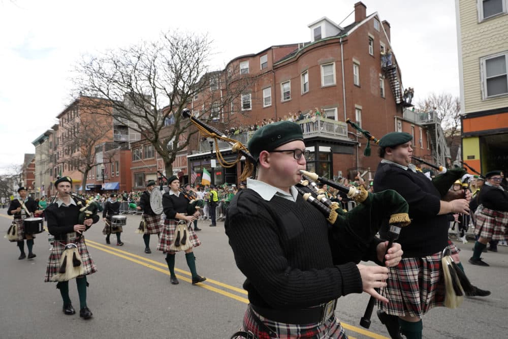 Members of Colonial Pipers play bagpipes as they march on Sunday. (Steven Senne/AP)