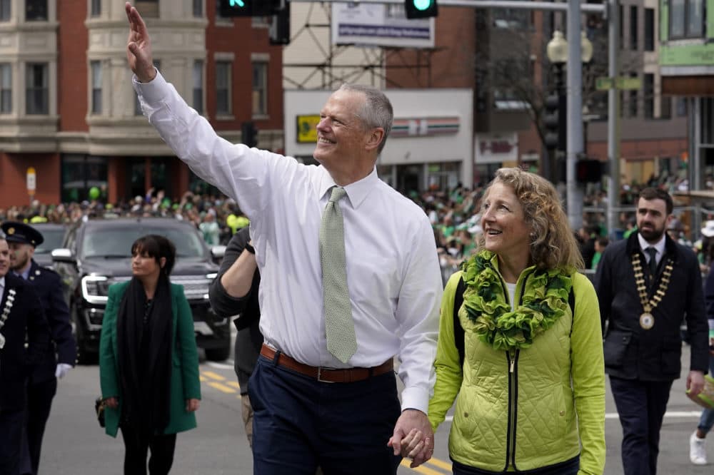 Massachusetts Gov. Charlie Baker waves while walking with his wife Lauren during the St. Patrick's Day parade on Sunday. (Steven Senne/AP)
