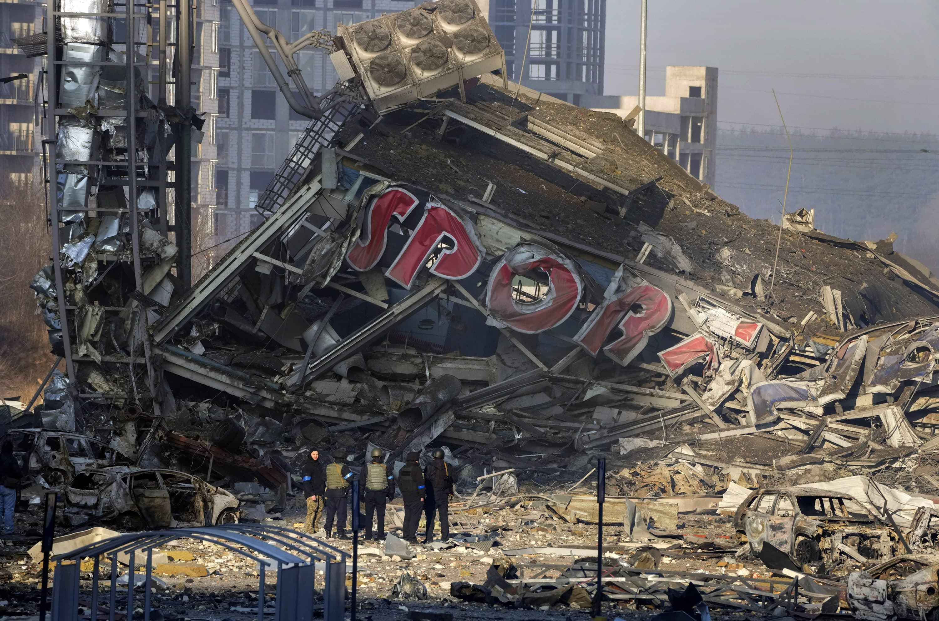 People examine the damage after shelling of a shopping center, in Kyiv, Ukraine, Monday, March 21, 2022. (Efrem Lukatsky/AP)