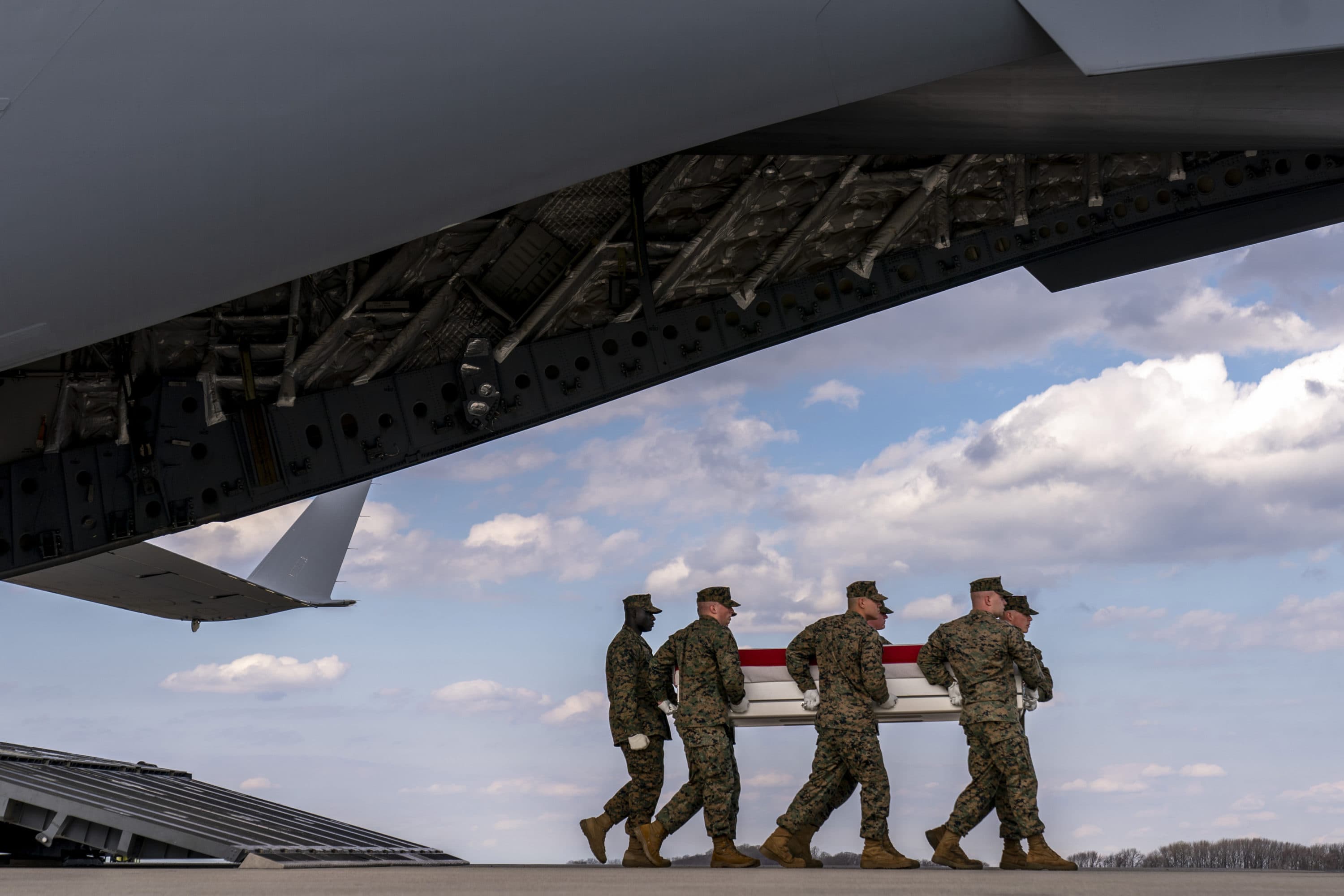 A U.S. Marine Corps carry team moves a transfer case containing the remains of Cpl. Jacob M. Moore of Catlettsburg, Ky., during a casualty return, Friday, March 25, 2022, at Dover Air Force Base. (Andrew Harnik/AP)