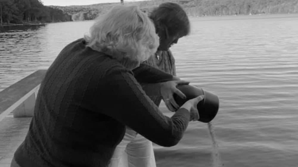 Elaine Pepe and her daughter, Shirley Bailey, spreading Jan’s ashes in the water near their home in Maryland in October 2020. (Michelle Burnett)