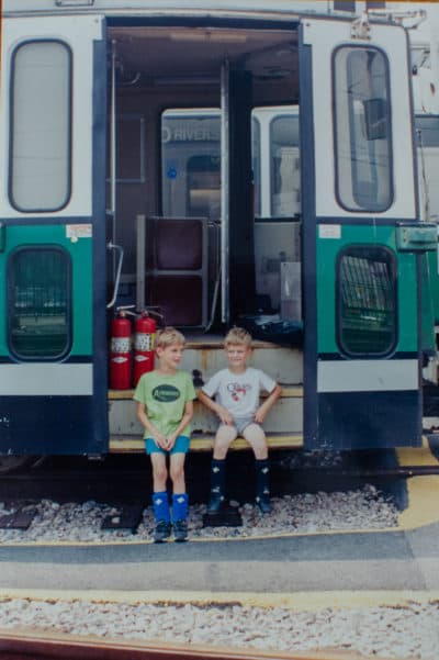 Sharon Brody's sons Jack and Campbell visiting some trolleys in the rail yard after soccer practice, back in the 1990s. (Sharon Brody/WBUR)