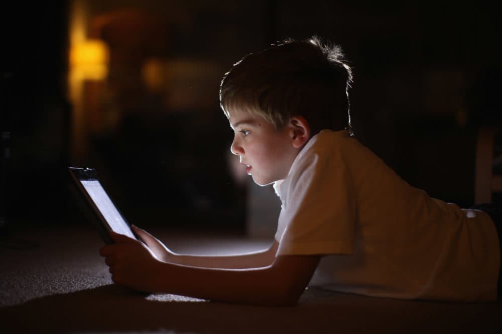 A 10-year-old boy uses an Apple iPad. (Christopher Furlong/Getty Images)
