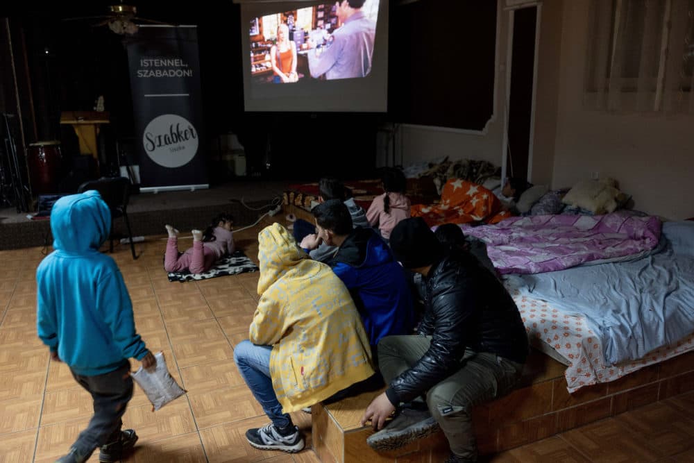 Refugee children watch movie at a temporary shelter offered by the "Free Christian Church" on March 20, 2022 in Uszka, Hungary. (Janos Kummer/Getty Images)