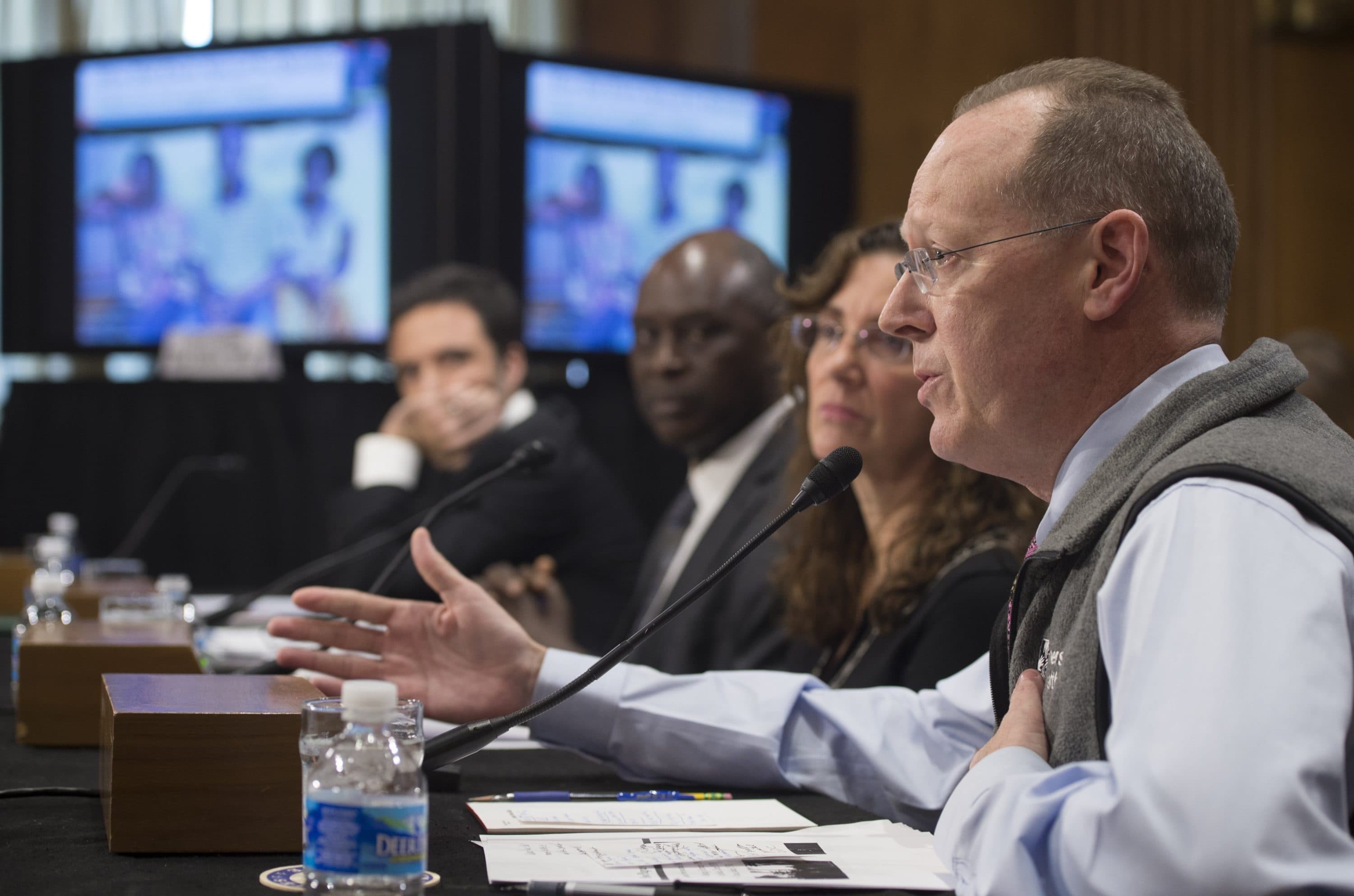 Paul Farmer (R), co-founder of Partners in Health, testifies on the international response to the ebola crisis during a Senate Foreign Relations African Affairs Subcommittee hearing on Capitol Hill in Washington, DC, December 10, 2014. (Saul Loeb/AFP via Getty Images)