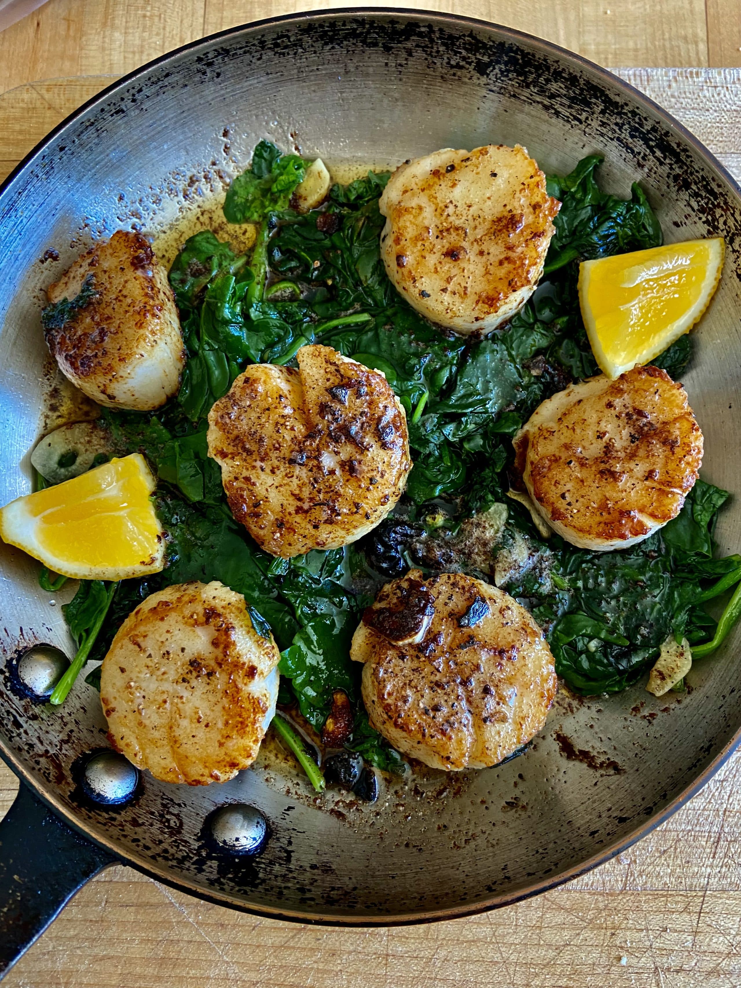 Sauteed scallops with spring spinach with brown butter-lemon sauce. (Kathy Gunst)