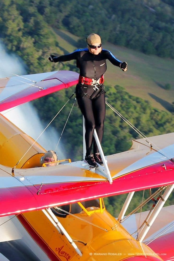 Jane Wicker standing on the top wing of her plane, Aurora. (Courtesy Mariano Rosales)