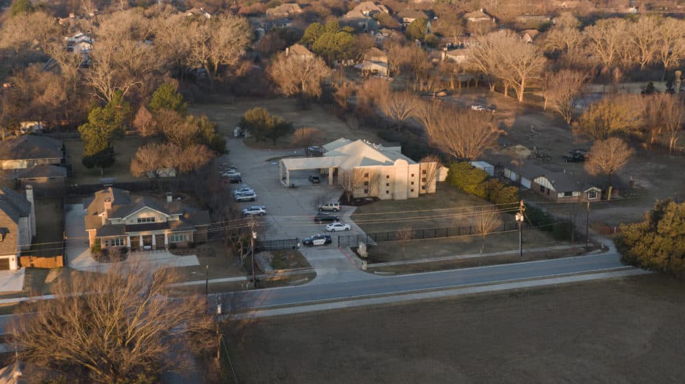 An aerial view of police standing in front of the Congregation Beth Israel synagogue,, Jan. 16, 2022, in Colleyville, Texas. A man held hostages for more than 10 hours Saturday inside the temple. (Brandon Wade/AP)
