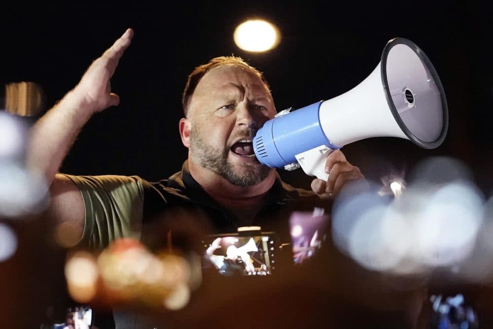 In this Nov. 5, 2020 file photo, radio host Alex Jones rallies pro-Trump supporters outside the Maricopa County Recorder's Office in Phoenix. The photo was taken by Matt York for The Associated Press.