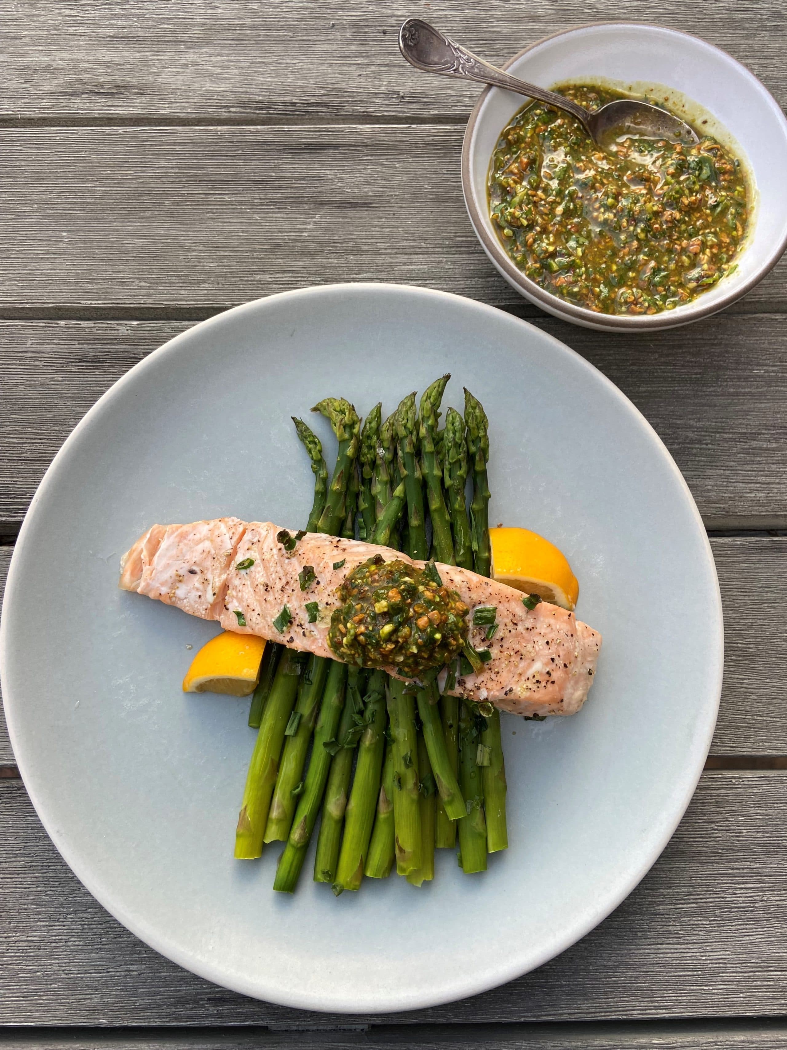 Salmon with asparagus and a pistachio-arugula pesto. (Kathy Gunst)