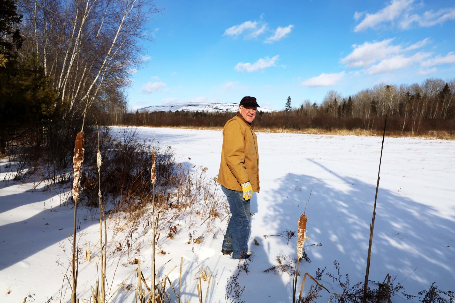 Ed Spencer, a West Old Town resident whose home is less than two miles from Juniper Ridge, looks at the dump from one part of town. (Esta Pratt-Kielley/Maine Public)