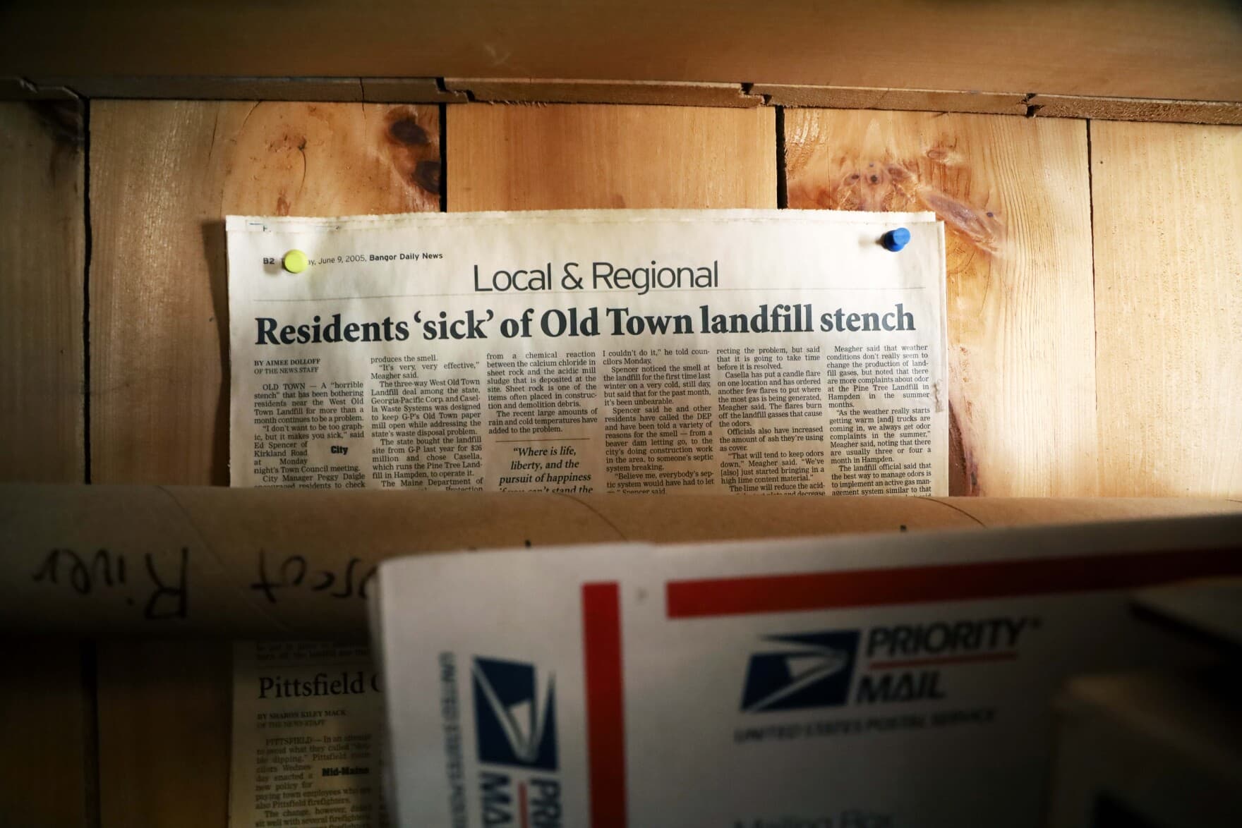 A clipping from a 2005 article in the Bangor Daily News that hangs in the home of Ed Spencer, a West Old Town resident who has opposed the out-of-state waste ending up at Juniper Ridge. (Esta Pratt-Kielley/Maine Public)