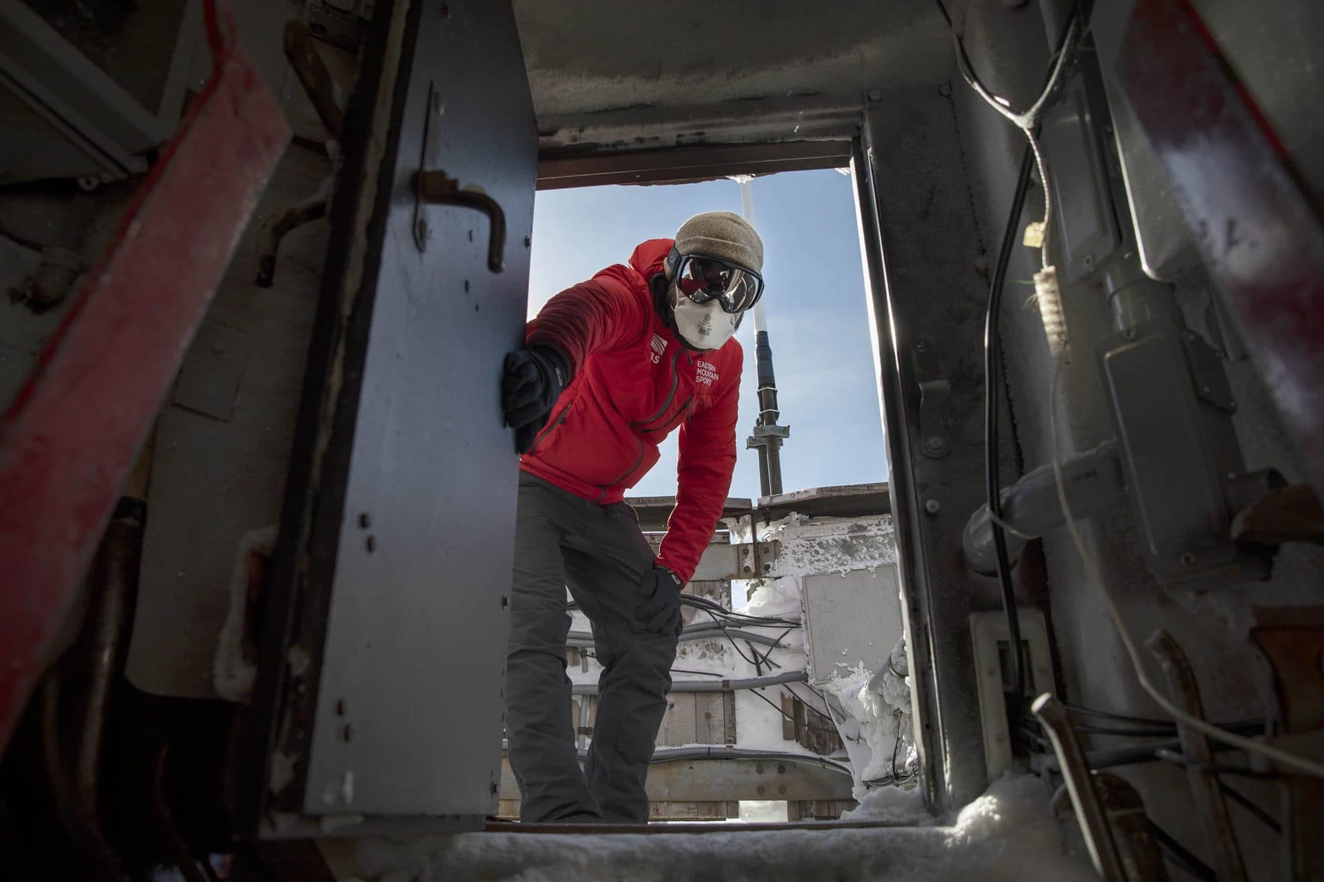 Science and education director Brian Fitzgerald holds open the door at the top of the weather tower at the Mount Washington Observatory. (Robin Lubbock/WBUR)