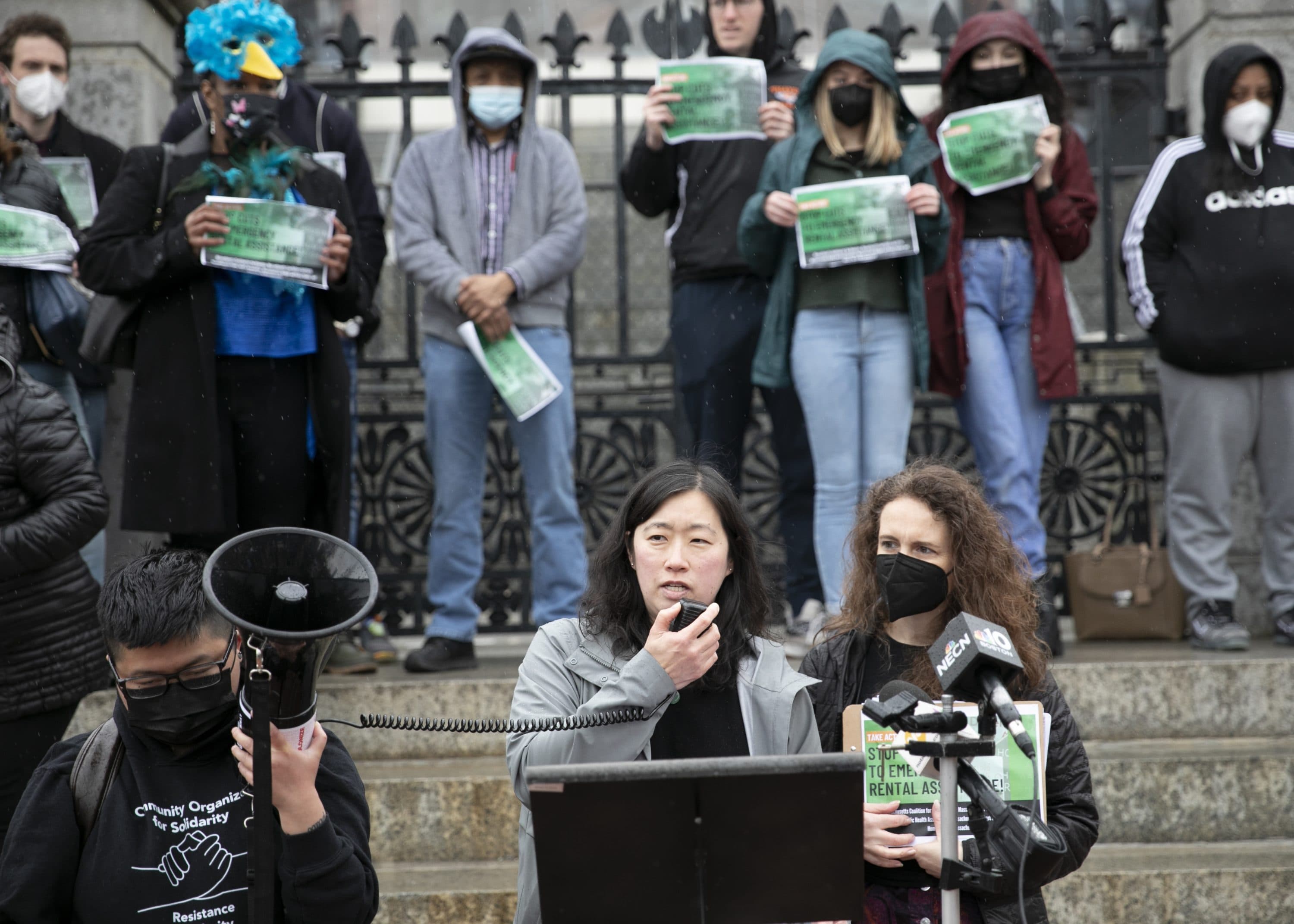 Massachusetts Law Reform Institute Director of Community Based Advocacy Andrea Park (left) joins other housing advocates outside the State House on Tuesday calling for lawmakers to tap into remaining federal aid to keep an emergency rental assistance program afloat beyond its Friday expiration. (Chris Lisinski/SHNS)