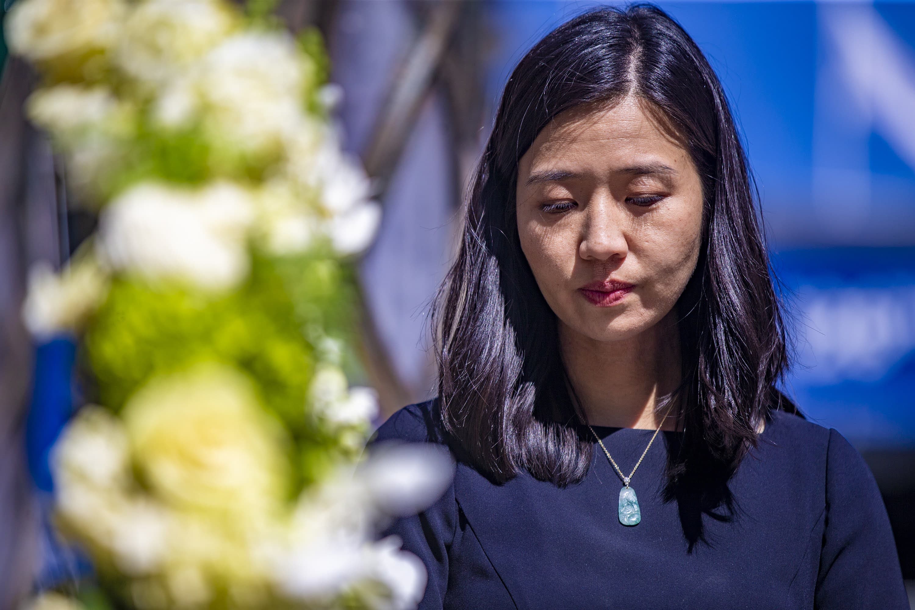 Wu stands during a moment of silence at the Marathon Bombing Memorial at 671 Boylston St. as the bells toll at the Old South Church. (Jesse Costa/WBUR)