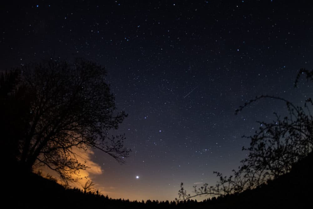 Shooting stars can be seen in the sky above a national park in Germany in April 2020, during the Lyrid meteor shower. (Marius Becker/picture alliance via Getty Images)
