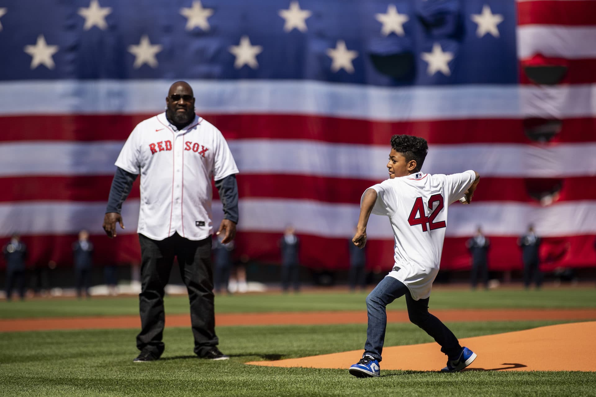 Former player Mo Vaughn of the Boston Red Sox watches as his son, Lee, throws out the ceremonial first pitch before the opening day game against the Minnesota Twins at Fenway Park. (Billie Weiss/Boston Red Sox/Getty Images)