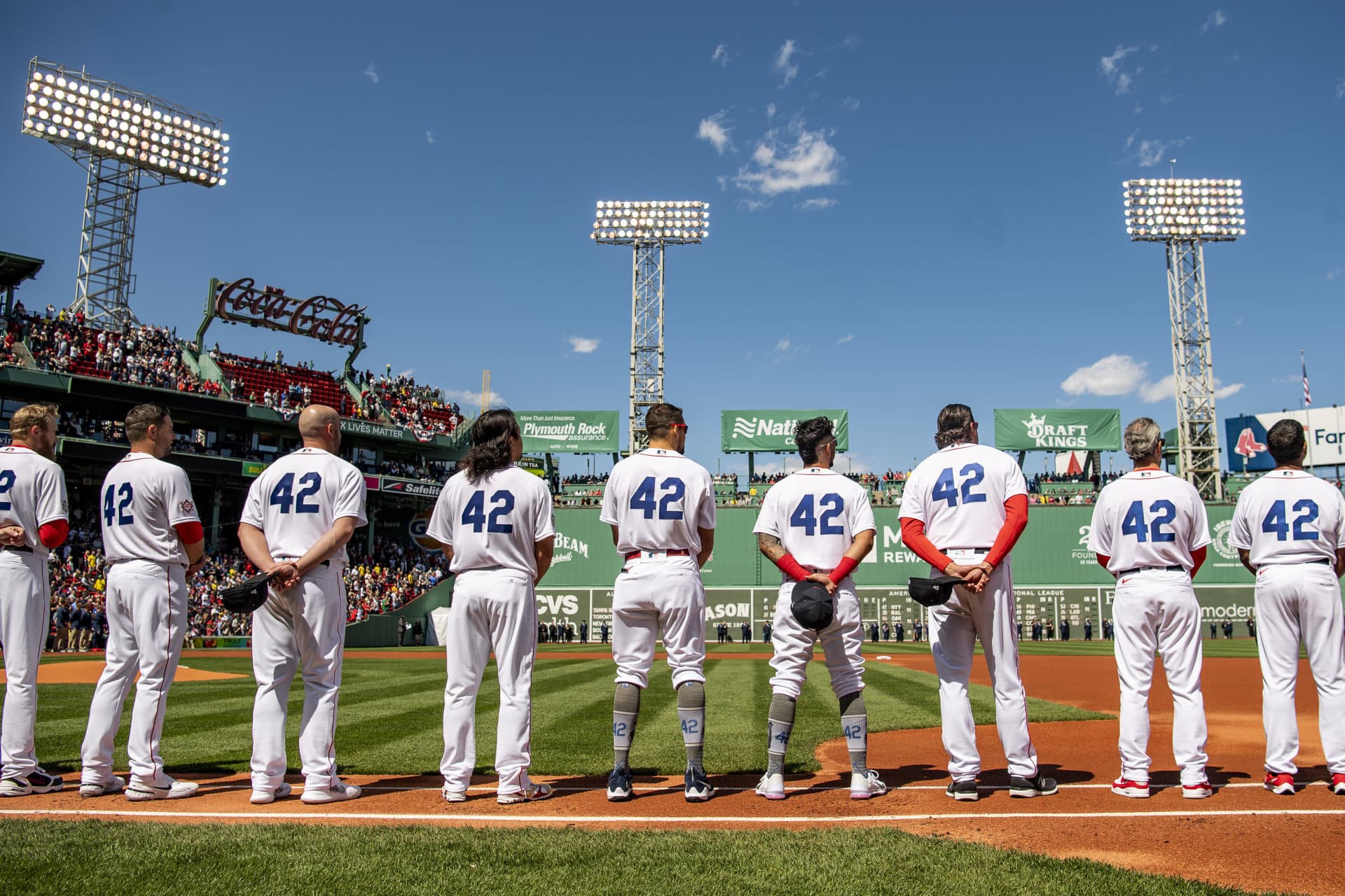 Members of the Boston Red Sox display the number 42 in recognition of Jackie Robinson Day, as starting lineups are introduced before the opening day game against the Minnesota Twins on April 15 at Fenway Park. (Billie Weiss/Boston Red Sox/Getty Images)