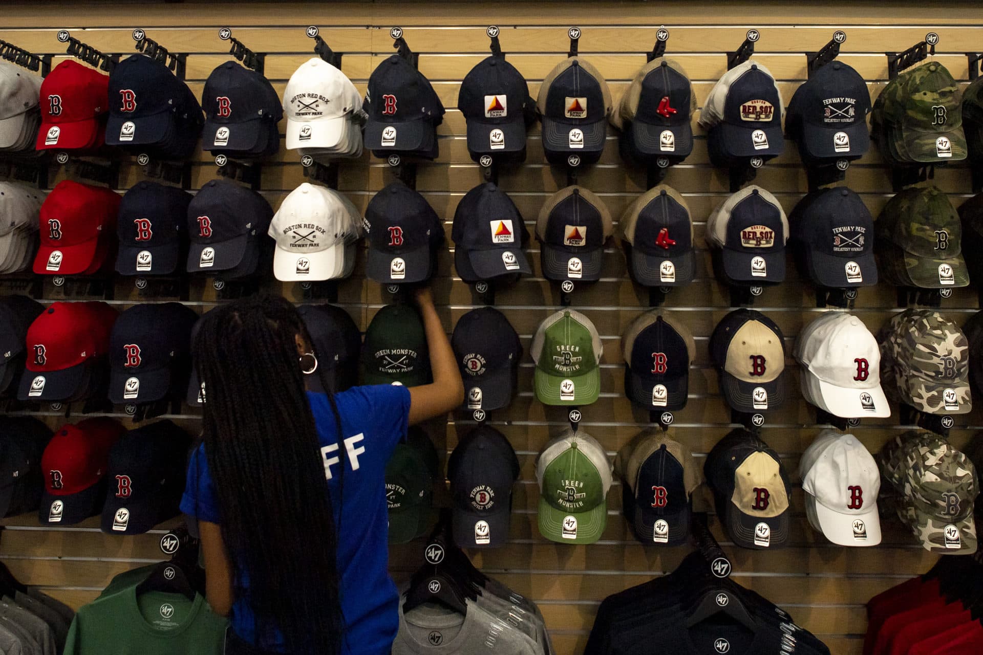 A team store employee stocks shelves before opening day. (Billie Weiss/Boston Red Sox/Getty Images)