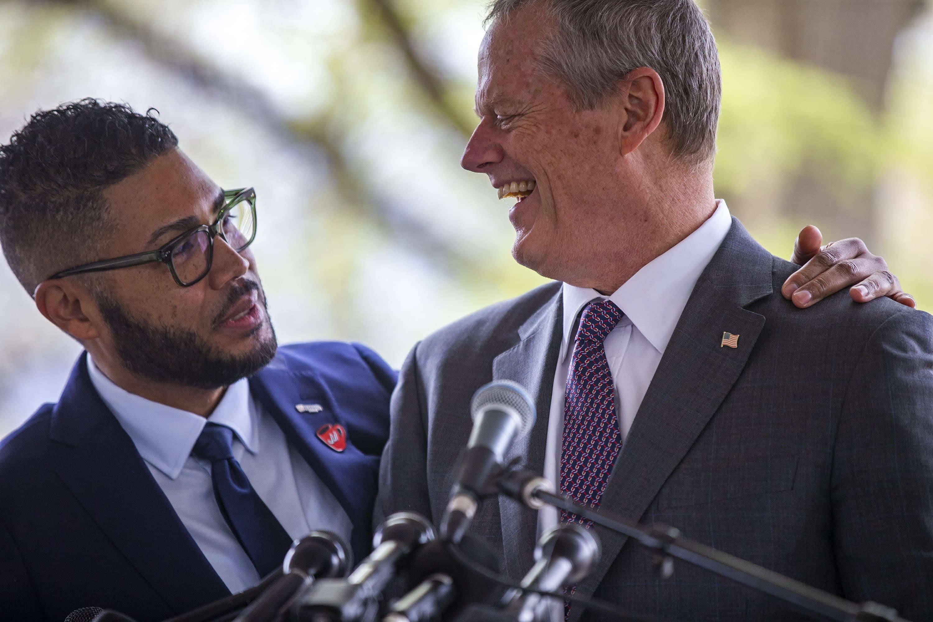 Imari Jeffries, executive director of King Boston, jokes with Gov. Charlie Baker before he speaks during the groundbreaking ceremony for the King memorial. (Jesse Costa/WBUR)