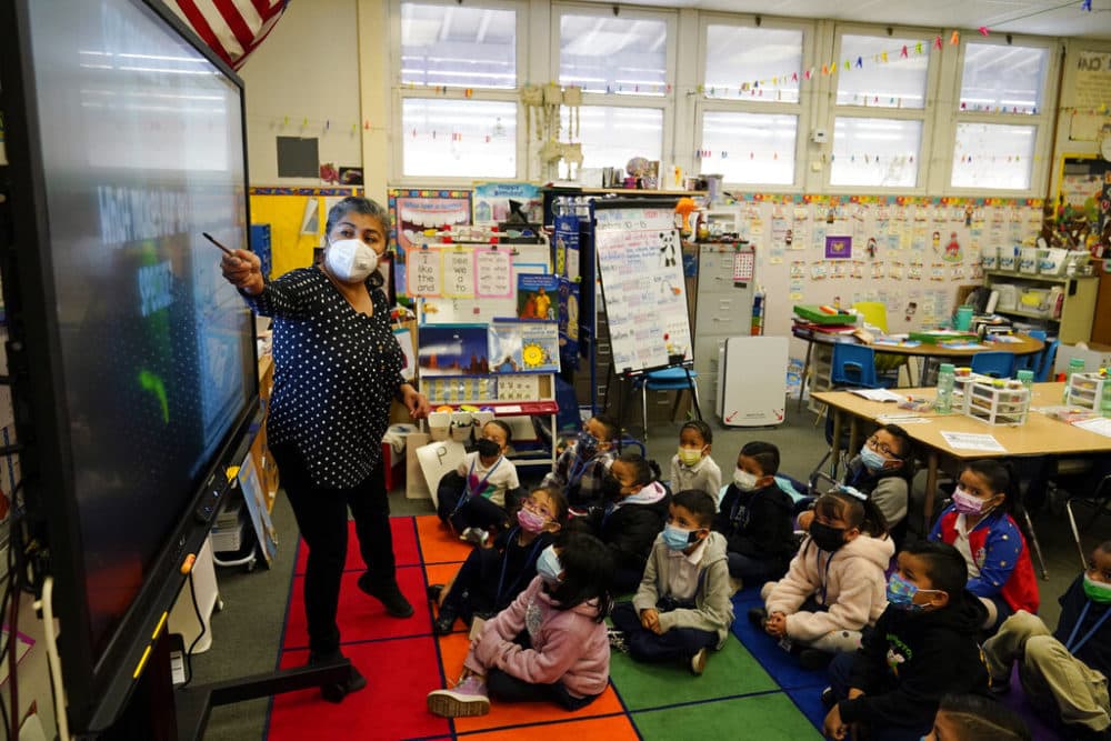 Kindergarten teacher Ana Zavala, at left, instructs students amid the COVID-19 pandemic at Washington Elementary School Wednesday, Jan. 12, 2022, in Lynwood, Calif.  California is making it easier for school districts to hire teachers and other employees amid staffing shortages brought on by the latest surge in coronavirus cases. (AP Photo/Marcio Jose Sanchez)
