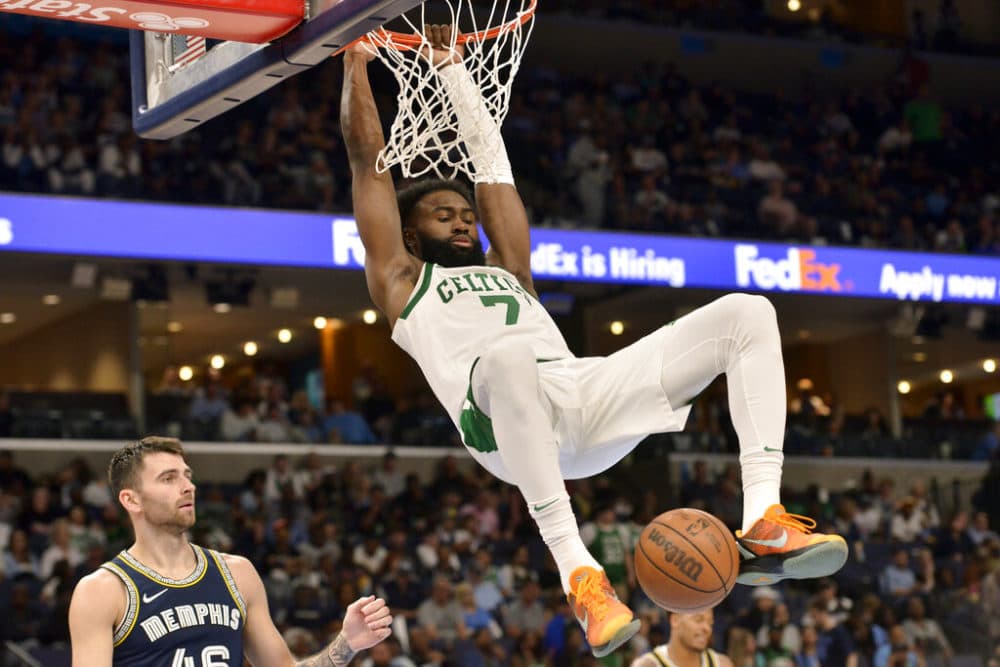 Boston Celtics guard Jaylen Brown (7) dunks ahead of Memphis Grizzlies guard John Konchar (46) in the second half of an NBA basketball game Sunday, April 10, 2022, in Memphis, Tenn. (AP Photo/Brandon Dill)