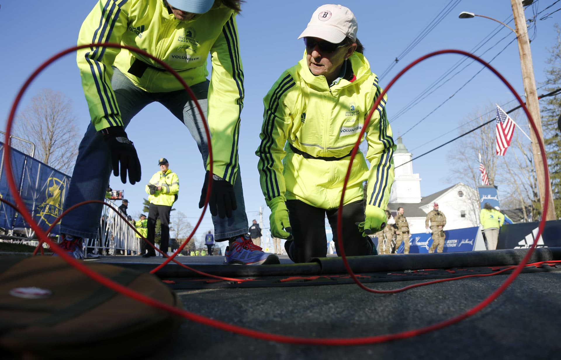 Volunteers set up the timing mats at the starting line before the start of the 126th Boston Marathon, Monday, April 18, 2022, in Hopkinton, Mass. (Mary Schwalm/AP)