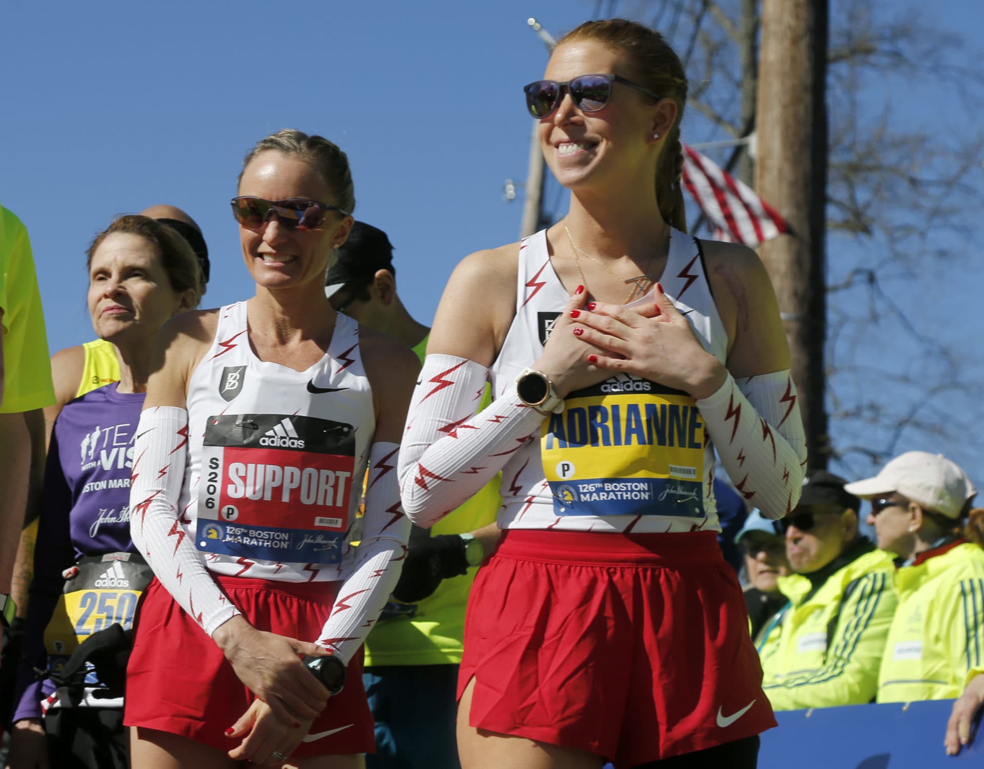 Boston Marathon bombing survivor Adrianne Haslet, right, reacts as she is introduced in the para division with Shalane Flanagan, left, as her support runner at the starting line of the 126th Boston Marathon, Monday, April 18, 2022, in Hopkinton, Mass. (Mary Schwalm/AP)