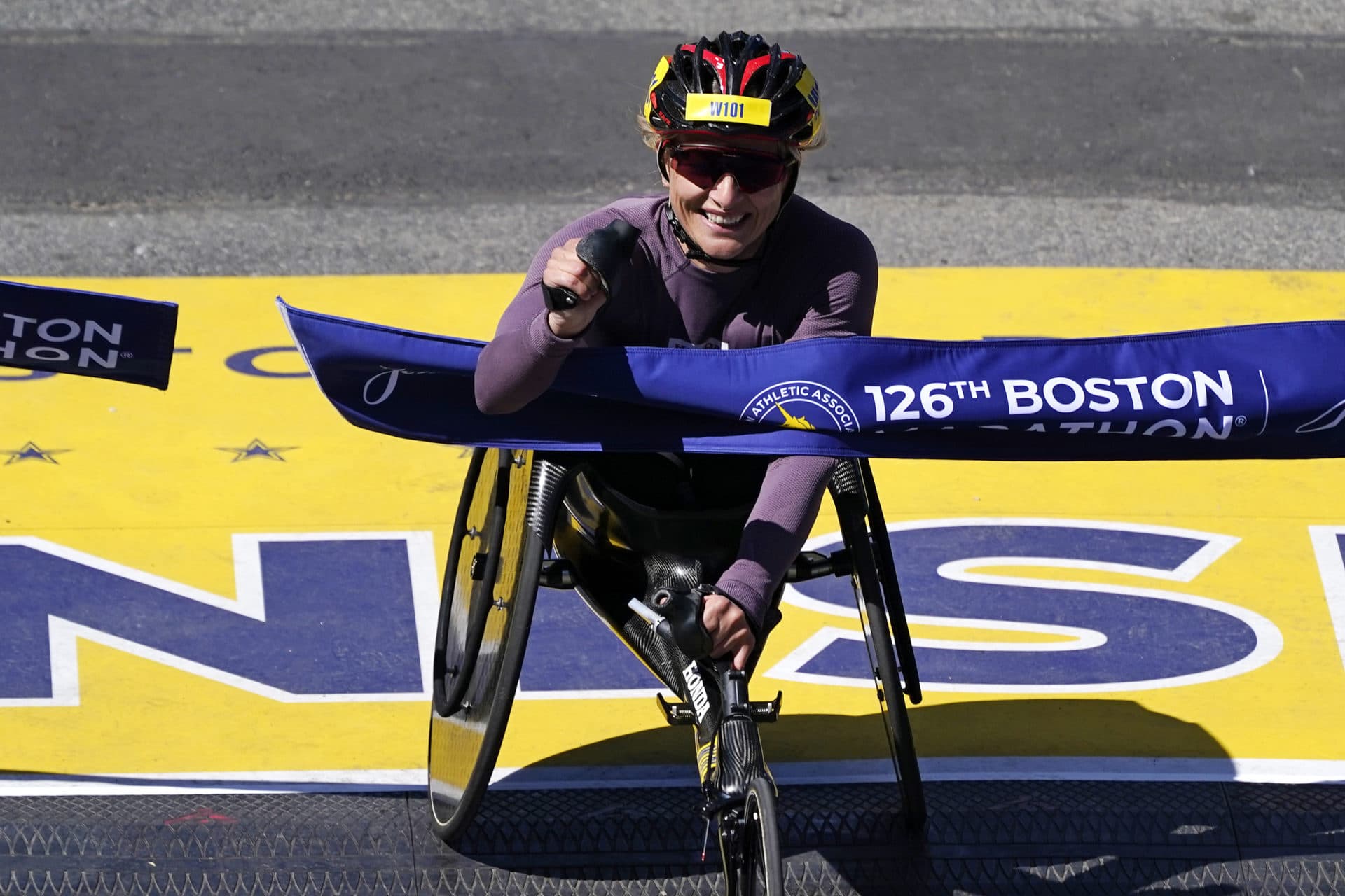 Manuela Schar, of Switzerland, breaks the tape to win the women's wheelchair division of the 2022 Boston Marathon. (Charles Krupa/AP)