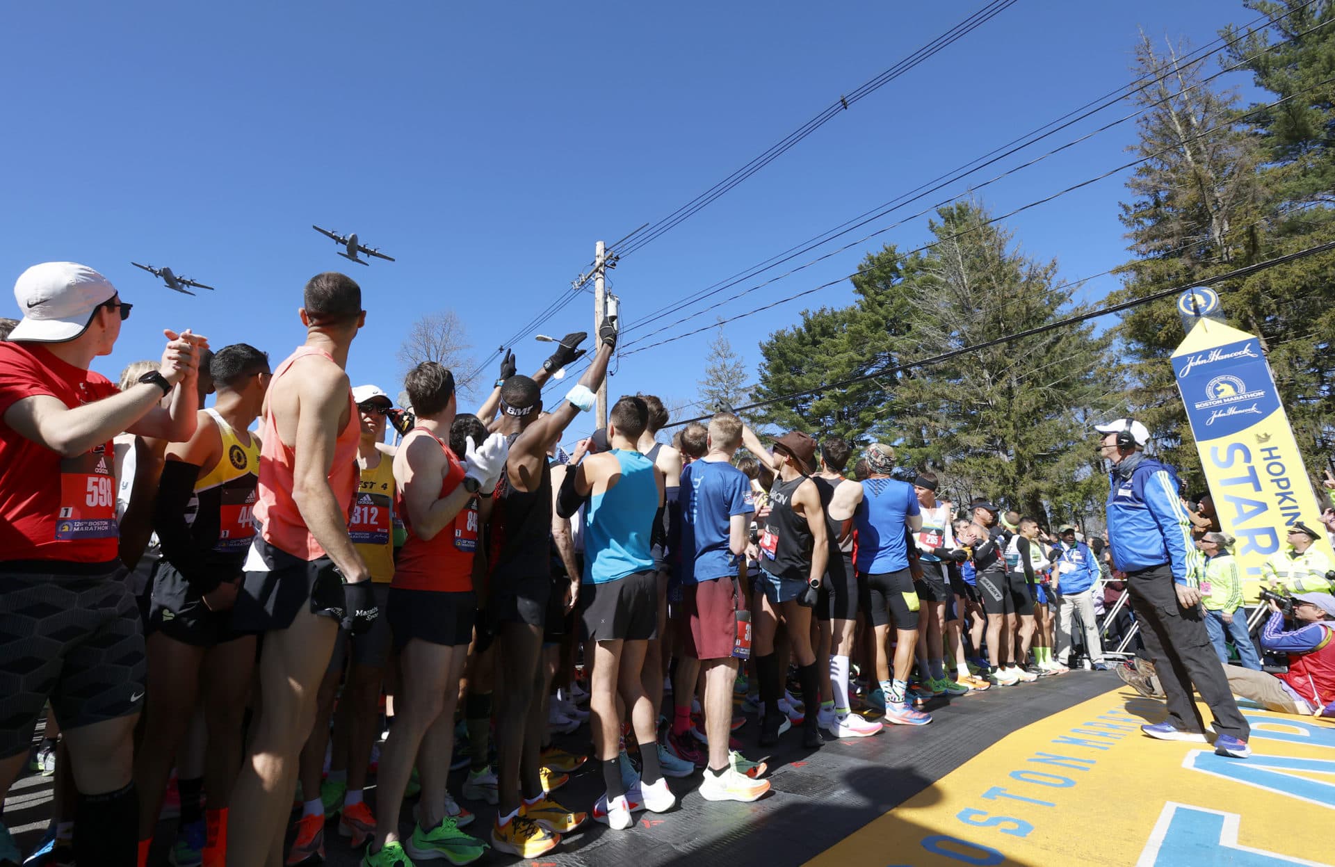 Two C-130s out of Bradley Air National Guard fly over the starting line of the 126th Boston Marathon. (Mary Schwalm/AP)