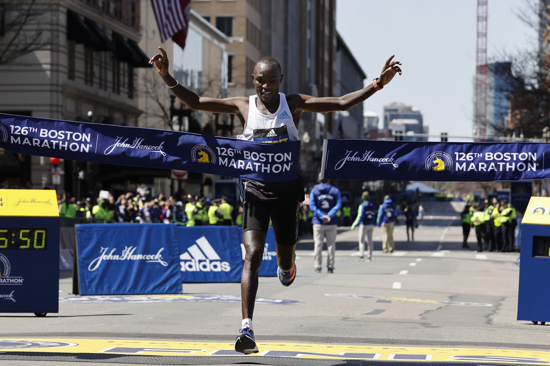 Evans Chebet, of Kenya, hits the tape to win the 126th Boston Marathon. (Winslow Townson/AP)