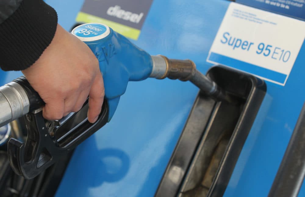 In Germany, a man replaces the nozzle of a gasoline pump after filling his car's tank with Super 95 E10 gasoline, which is a blend of gasoline and 10% ethanol. (Sean Gallup/Getty Images)