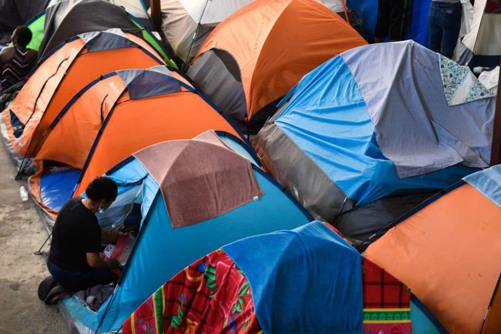 Families with children live in tents the Movimiento Juventud 2000 shelter with refugee migrants from Central and South American countries including Honduras and Haiti seeking asylum in the United States, as Title 42 and Remain In Mexico border restrictions continue, in Tijuana, Baja California state, Mexico on April 9, 2022. (Patrick T. Fallon/AFP via Getty Images)